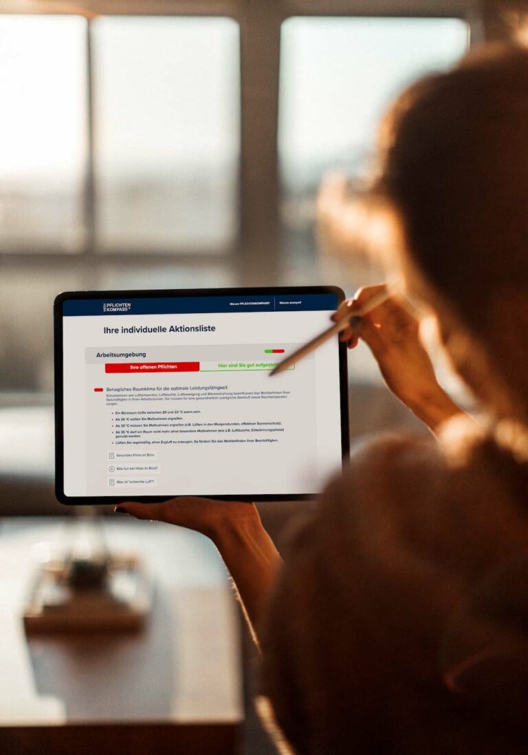 Photo of a woman tapping on a tablet with a pen